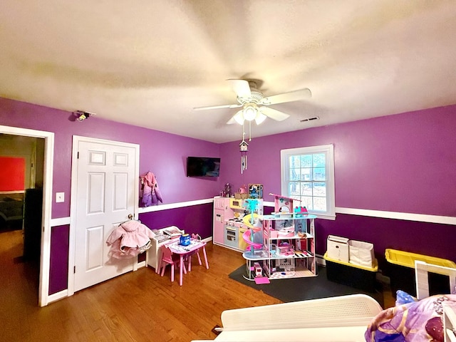 bedroom with wood-type flooring and ceiling fan