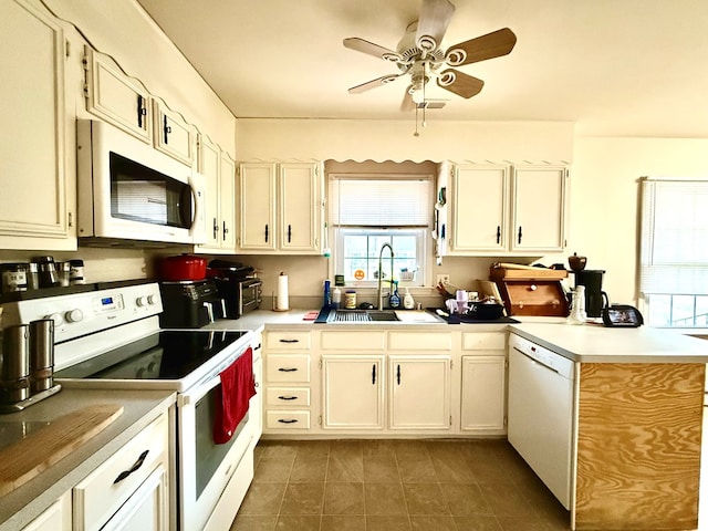 kitchen featuring ceiling fan, white appliances, and sink