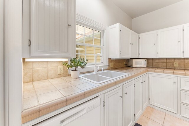 367 Edgewater Ln, Montross, VA 22520 - kitchen with a sink, white appliances, white cabinets, tasteful backsplash, and light tile patterned floors