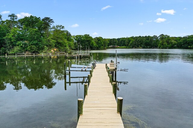 367 Edgewater Ln, Montross, VA 22520 - dock with boat lift, a water view, and a forest view