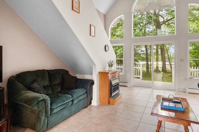 367 Edgewater Ln, Montross, VA 22520 - living room with plenty of natural light, light tile patterned floors, high vaulted ceiling, and a baseboard heating unit