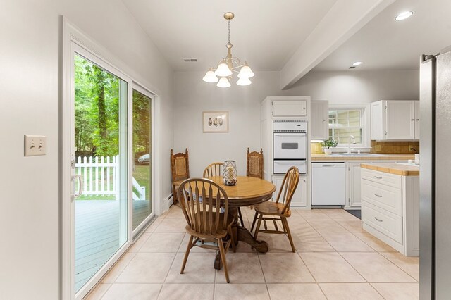 367 Edgewater Ln, Montross, VA 22520 - dining space featuring light tile patterned flooring, a chandelier, and recessed lighting