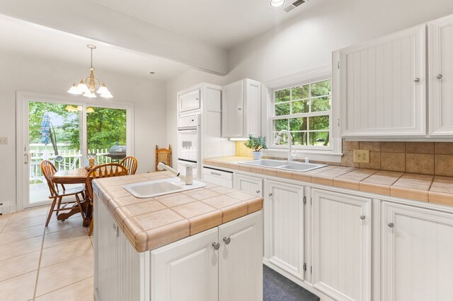 367 Edgewater Ln, Montross, VA 22520 - kitchen featuring a sink, tile countertops, and white cabinetry
