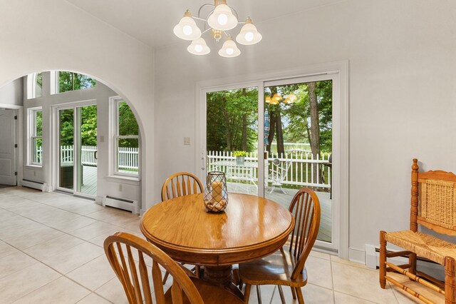 367 Edgewater Ln, Montross, VA 22520 - dining area featuring light tile patterned flooring, healthy amount of natural light, a chandelier, and a baseboard heating unit