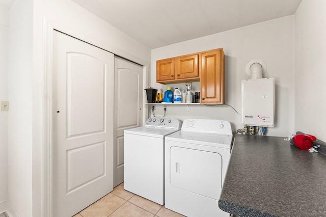 367 Edgewater Ln, Montross, VA 22520 - washroom featuring cabinet space, separate washer and dryer, tankless water heater, and light tile patterned floors