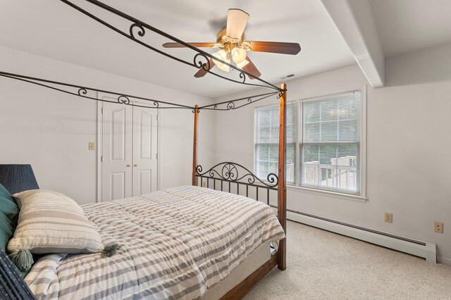 367 Edgewater Ln, Montross, VA 22520 - carpeted bedroom with a baseboard heating unit, ceiling fan, baseboards, and a closet