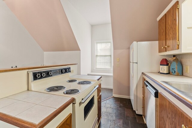 367 Edgewater Ln, Montross, VA 22520 - kitchen featuring white electric range, stone tile floors, stainless steel dishwasher, tile counters, and baseboards