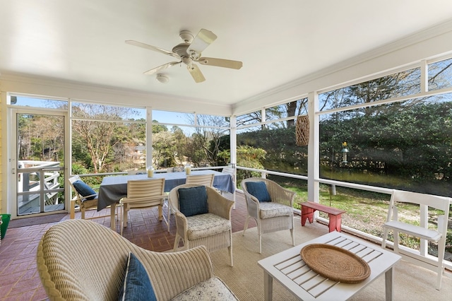 sunroom featuring ceiling fan