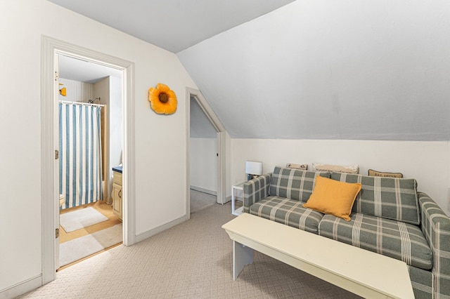 carpeted bedroom with baseboards and vaulted ceiling