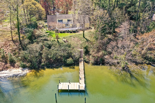 dock area with a water view and a forest view