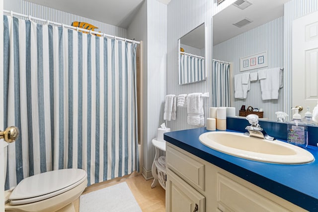 bathroom featuring vanity, a shower with curtain, and wallpapered walls