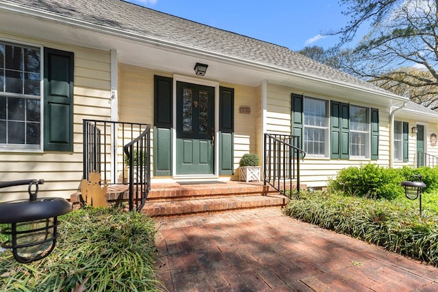 property entrance with a shingled roof