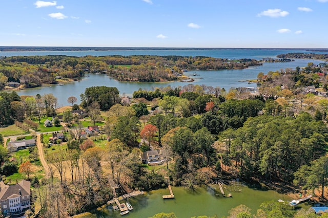drone / aerial view featuring a water view and a forest view