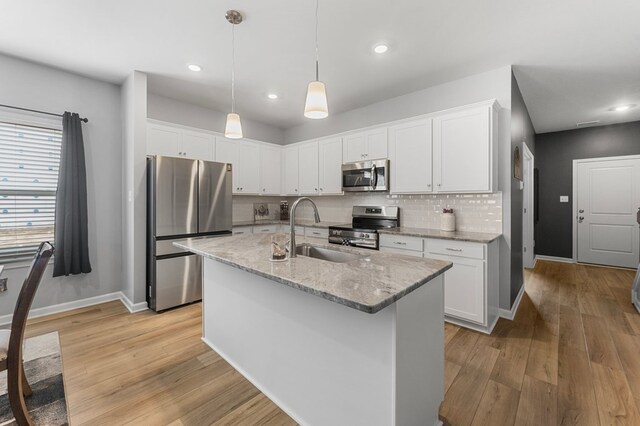 557 Wendenburg Ter, Aylett, VA 23009 - kitchen with appliances with stainless steel finishes, a sink, baseboards, tasteful backsplash, and white cabinets