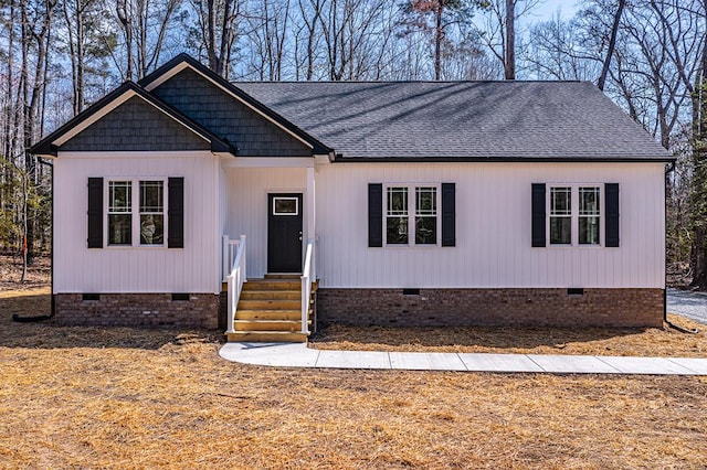 view of front facade with crawl space, roof with shingles, and entry steps