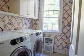 567 Seaford Ln, Mathews, VA 23109 - washroom featuring washer and dryer, plenty of natural light, and cabinets