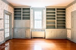 567 Seaford Ln, Mathews, VA 23109 - unfurnished living room featuring hardwood / wood-style floors, built in features, and crown molding