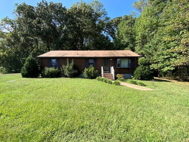 ranch-style home featuring a front yard