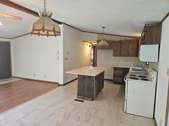 kitchen with dark brown cabinetry, sink, crown molding, white appliances, and a kitchen island