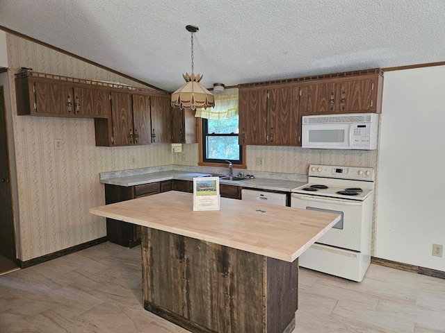 kitchen featuring white appliances, sink, vaulted ceiling, a textured ceiling, and decorative light fixtures