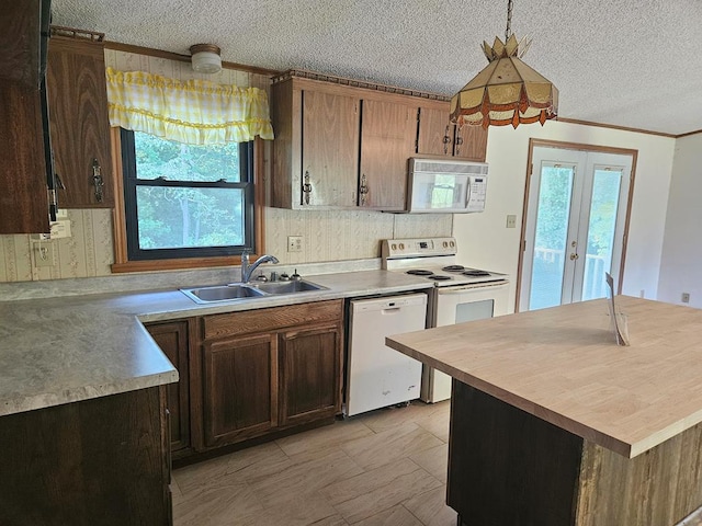 kitchen featuring french doors, sink, a textured ceiling, decorative light fixtures, and white appliances