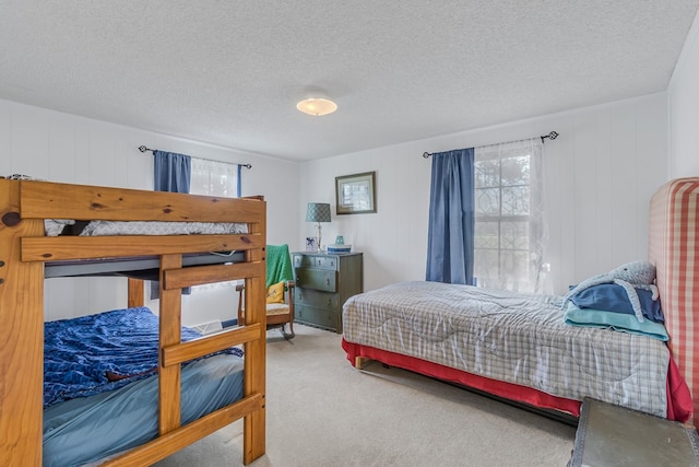 bedroom featuring carpet floors and a textured ceiling