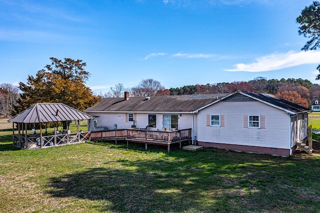 rear view of property with a gazebo, a lawn, and a deck