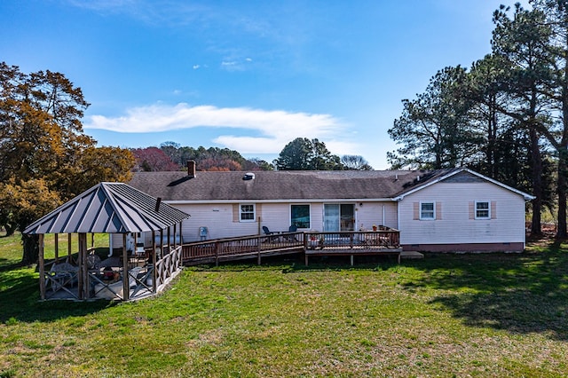 back of property with a gazebo, a yard, and a wooden deck