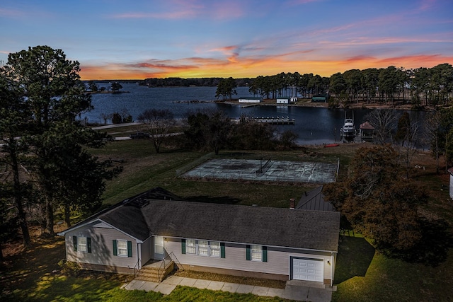 aerial view at dusk with a water view