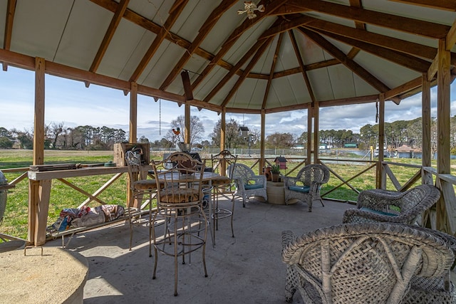 sunroom / solarium featuring lofted ceiling