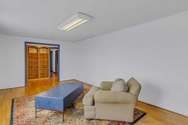 living room with hardwood / wood-style flooring and a textured ceiling