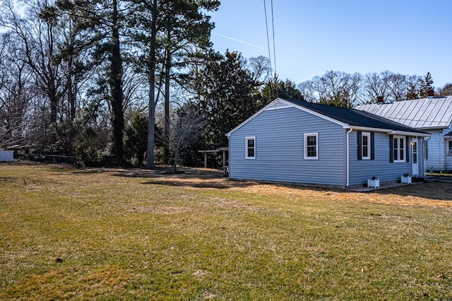 view of home's exterior with a yard