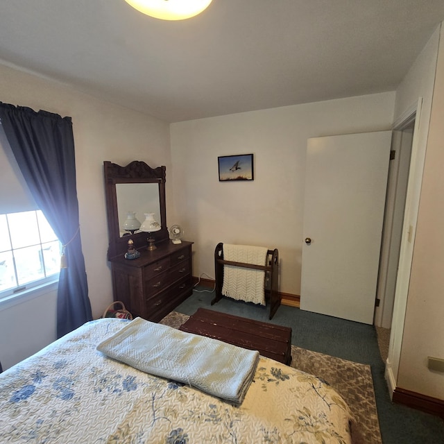 bedroom featuring carpet floors and baseboards