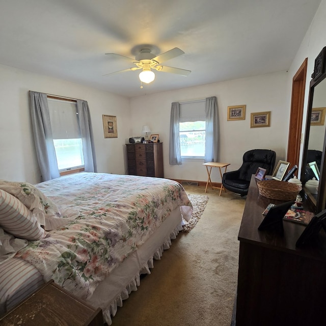 bedroom with ceiling fan and light colored carpet