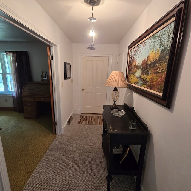 corridor featuring carpet and baseboards