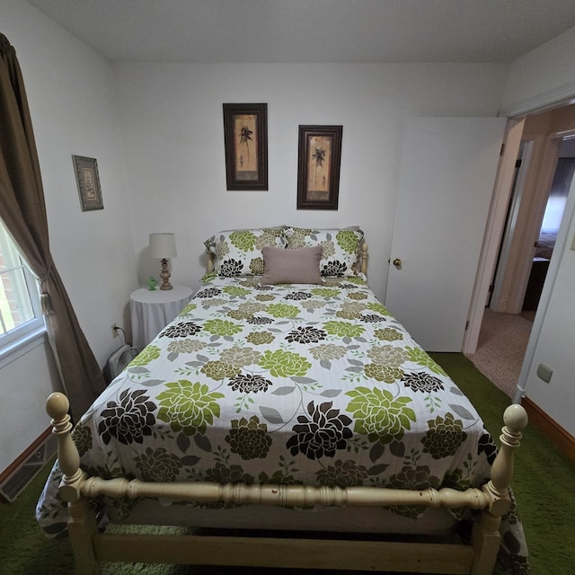 bedroom with visible vents and carpet flooring