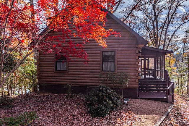 view of side of property featuring a sunroom