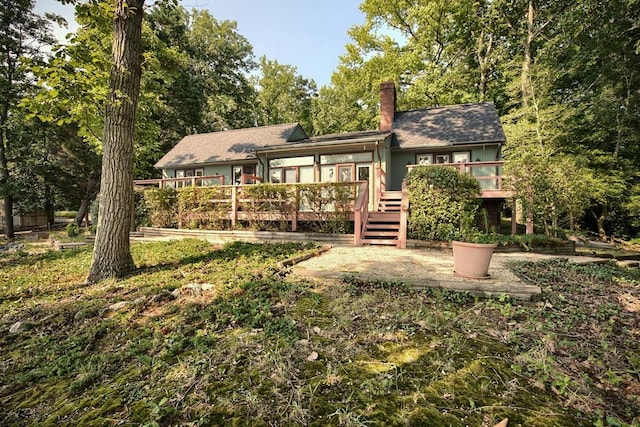 1061 Twiggs Ferry Rd, Hartfield, VA 23071 - rear view of property with a deck and a chimney
