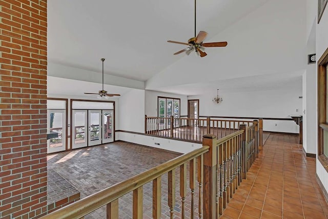 1061 Twiggs Ferry Rd, Hartfield, VA 23071 - hall featuring high vaulted ceiling, an upstairs landing, tile patterned flooring, and a chandelier