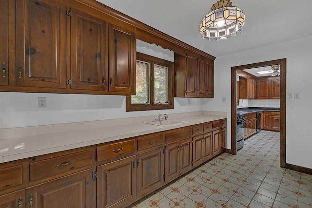 1061 Twiggs Ferry Rd, Hartfield, VA 23071 - kitchen featuring decorative light fixtures, light countertops, range, dishwasher, and light floors