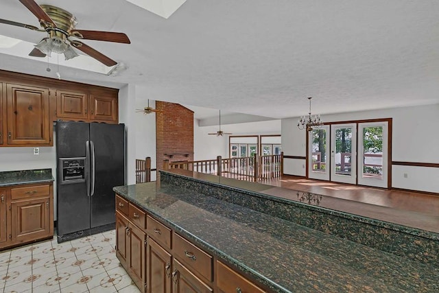 1061 Twiggs Ferry Rd, Hartfield, VA 23071 - kitchen featuring black refrigerator with ice dispenser, a ceiling fan, plenty of natural light, and a chandelier