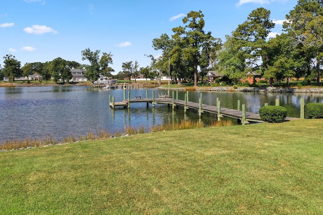 dock area featuring a water view and a lawn