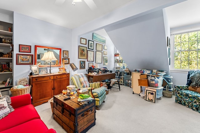 office area with a ceiling fan and light colored carpet