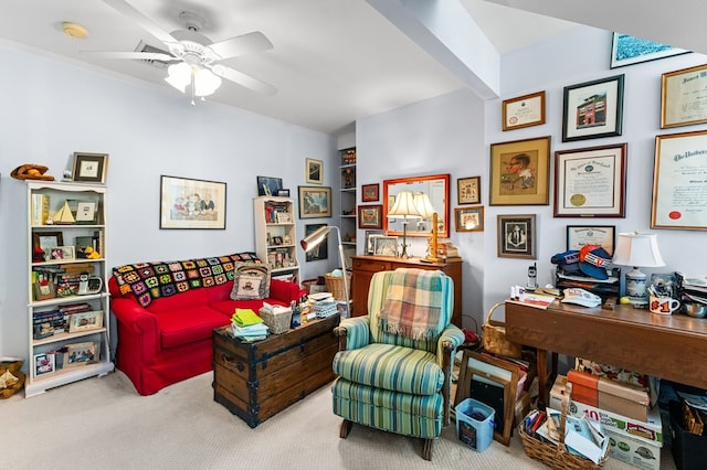 sitting room with ceiling fan and light colored carpet