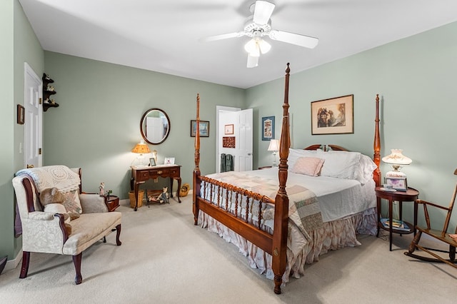 bedroom with light carpet, a ceiling fan, and baseboards