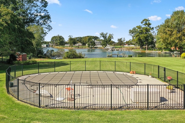 view of pool with a fenced in pool, a water view, a yard, and fence