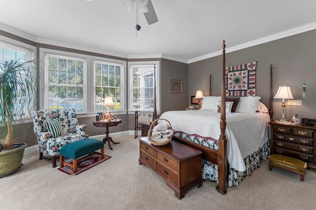 carpeted bedroom with ceiling fan and ornamental molding