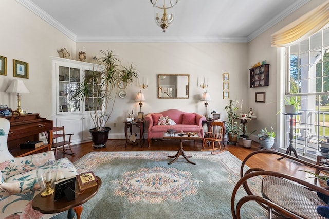 living room featuring crown molding, baseboards, and wood finished floors