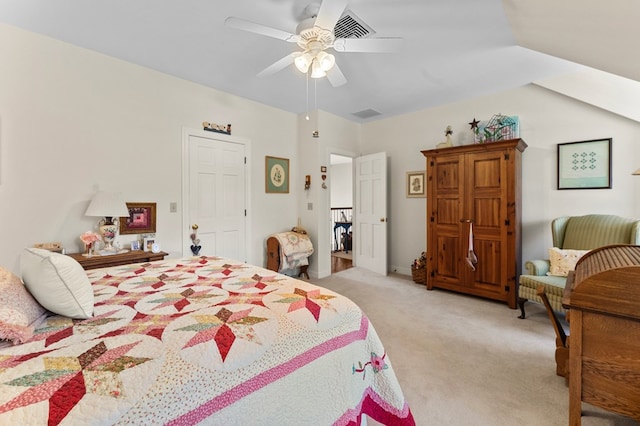 bedroom with light carpet, visible vents, vaulted ceiling, and a ceiling fan