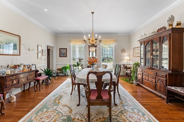 dining space with dark hardwood / wood-style flooring, a chandelier, and ornamental molding